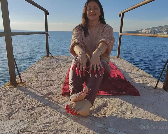 Lora Long Nails aka Loralongnails OnlyFans - Wearing red leggings, I am seated on the pier with my long, sharp red fingernails and rectangular