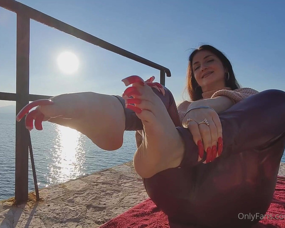 Lora Long Nails aka Loralongnails OnlyFans - Wearing red leggings, I am seated on the pier with my long, sharp red fingernails and rectangular