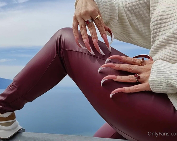 Lora Long Nails aka Loralongnails OnlyFans - Im sitting on a roadside barrier high up in the mountains overlooking the city, wearing burgundy